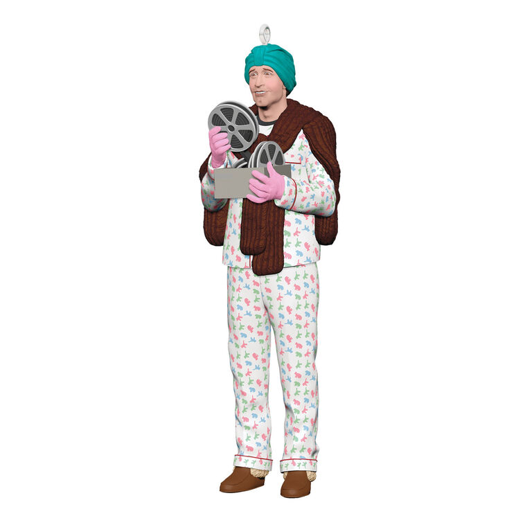 Hallmark Keepsake ornament of Clark Griswold in pajamas, fur stole, gloves, and turban holding a projector from National Lampoon&