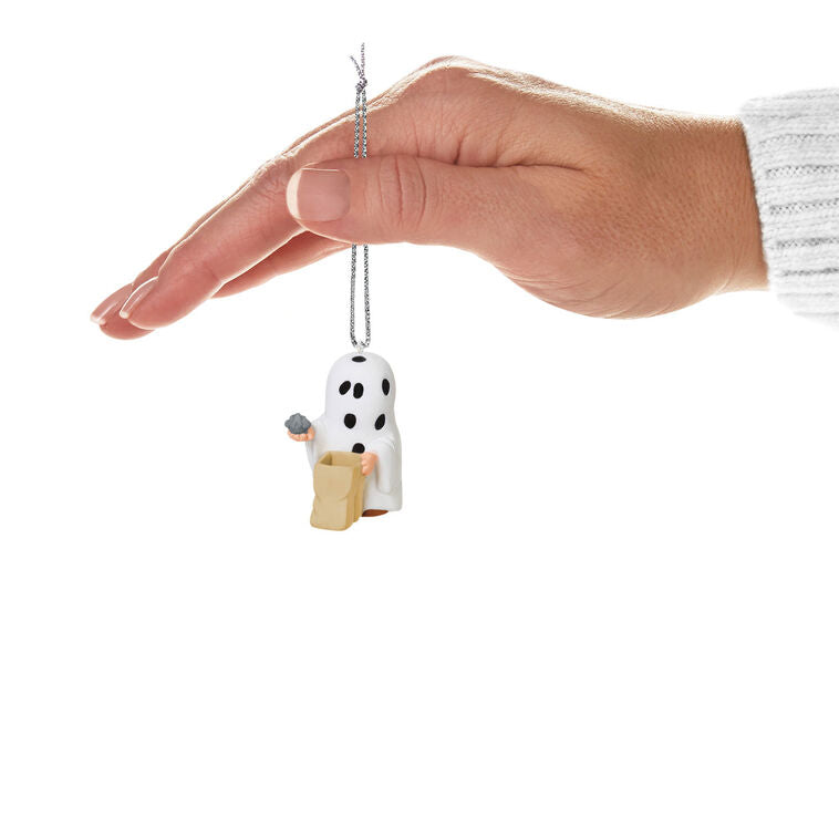 Miniature Charlie Brown Halloween ornament dressed as ghost holding rock from Peanuts Gang