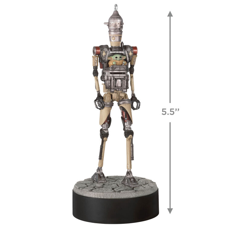 Ornament of Grogu piloting IG-12 droid from Star Wars: The Mandalorian™, on round base with sound button for “Yes” and “No” phrases.