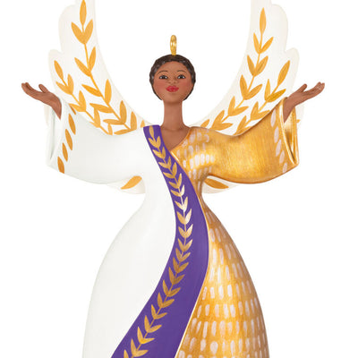 Angel ornament in gold, white, and purple gown with raised hands and detailed wings, a radiant Hallmark Keepsake holiday symbol of faith.