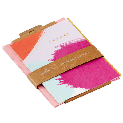 Vibrant thank-you cards with pink, orange, and mint brushstrokes and gold foil lettering.
