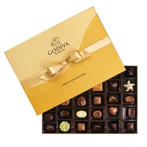 A 36-piece Godiva Ballotin gold box tied with a gold ribbon, filled with assorted milk, white, and dark chocolates with ganache, fruit, and nut fillings.

