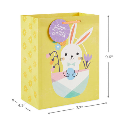 Hallmark Easter gift bag with white bunny in pastel basket on yellow background and floral accents.