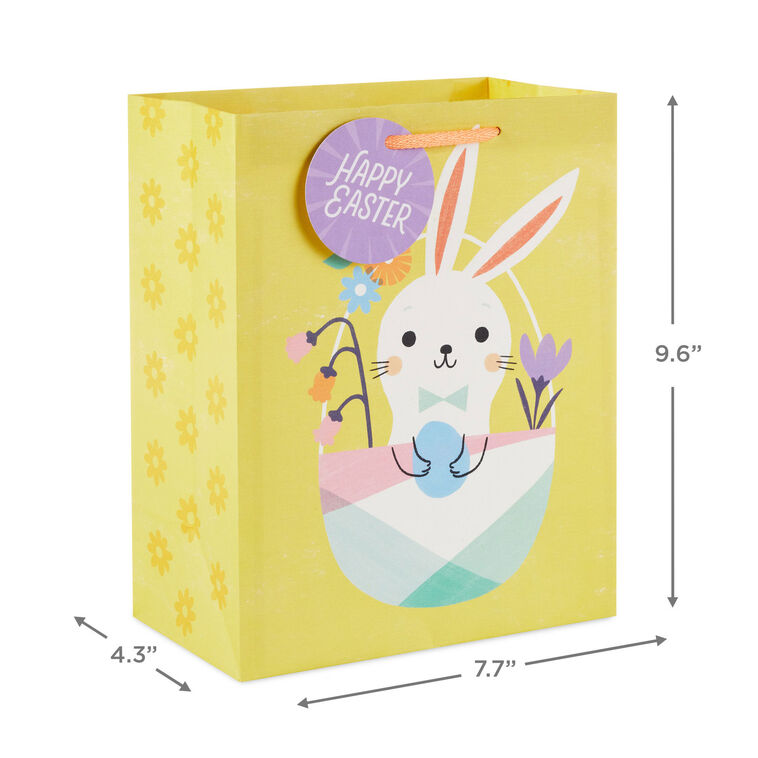 Hallmark Easter gift bag with white bunny in pastel basket on yellow background and floral accents.
