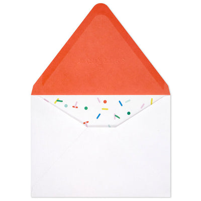 White envelopes with colorful confetti sprinkle design and orange flap interior, perfect for festive notes.
