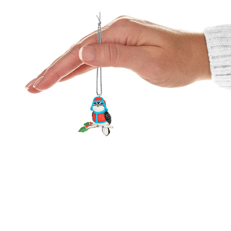 Miniature downy woodpecker ornament in red vest and trapper hat on snowy branch with holly berries, Hallmark Cozy Lil’ Critters
