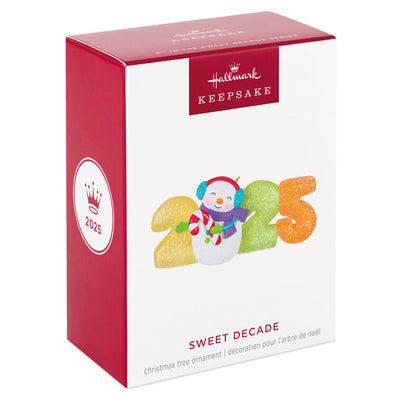 Hallmark Keepsake Sweet Decade 2025 ornament—snowman in purple scarf and blue earmuffs with candy cane, surrounded by glittery gumdrop “2025” numbers