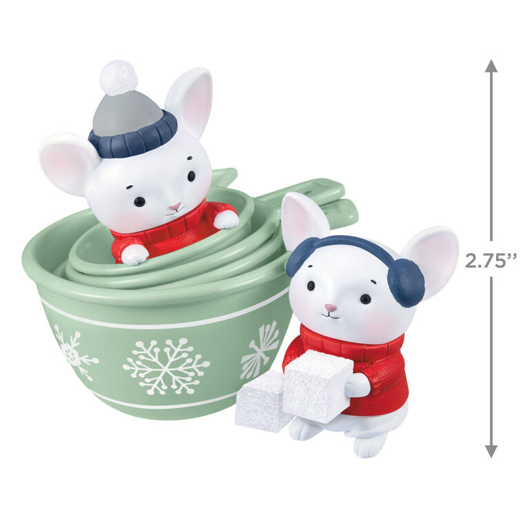 Christmas ornament with two mice in red sweaters and green measuring cups decorated with snowflakes, festive baking theme


