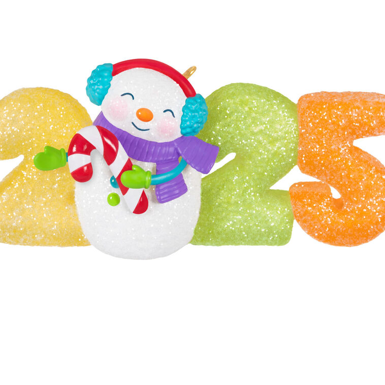 Hallmark Keepsake Sweet Decade 2025 ornament—snowman in purple scarf and blue earmuffs with candy cane, surrounded by glittery gumdrop “2025” numbers