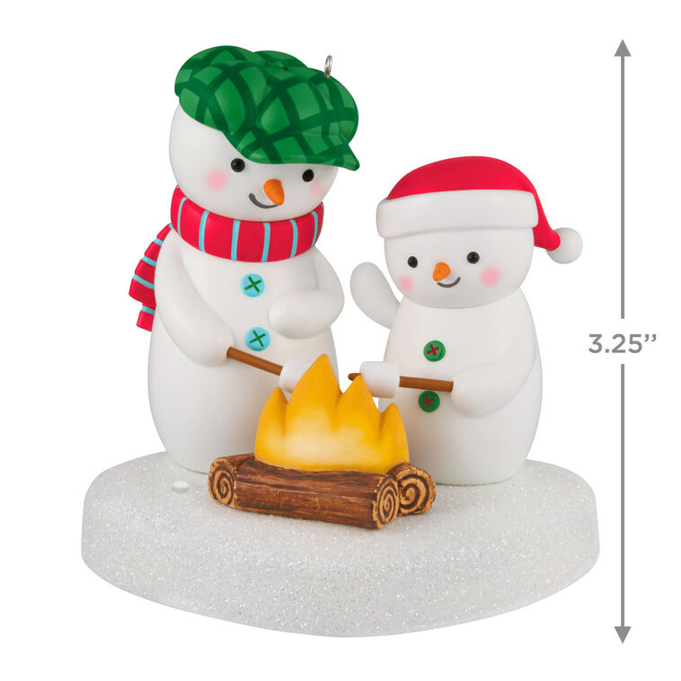 Two snowmen in red and green hats roasting marshmallows over a fire, sparkly base, musical Christmas ornament, battery opera
