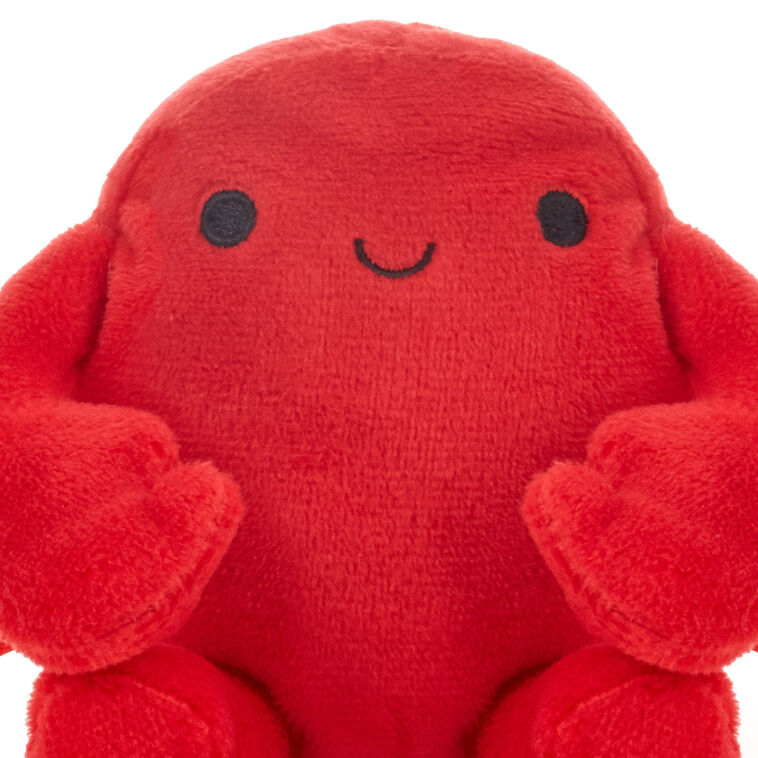 Smiling red plush crab with wire claws holding a gift card, perfect for fun gift presentation.
