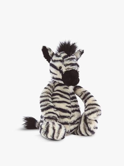 "A plush black and white zebra toy with a floppy mane and stitched eyes. It sits upright on a white background."