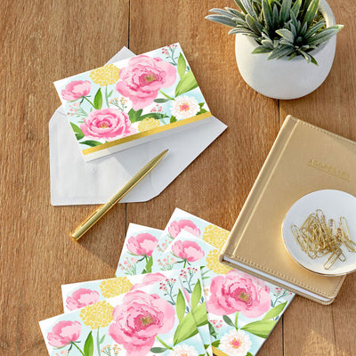 Pink and yellow floral note cards with green leaves on a sky-blue background, framed with gold foil border.
