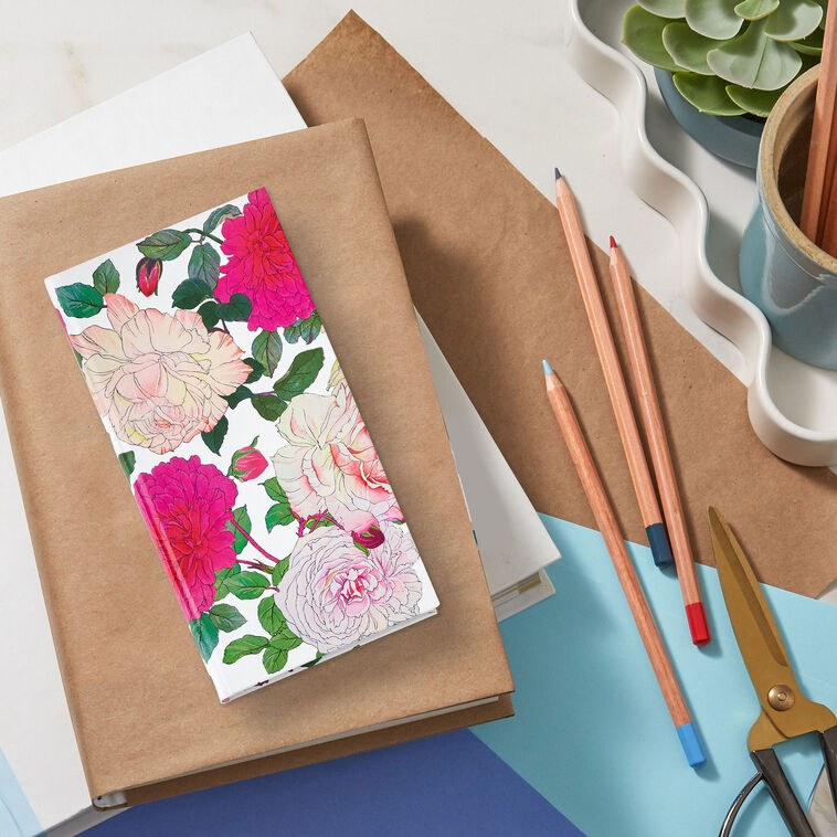 Password keeper book with fuchsia and cream floral cover, alphabetical tabs, and striped end sheets.