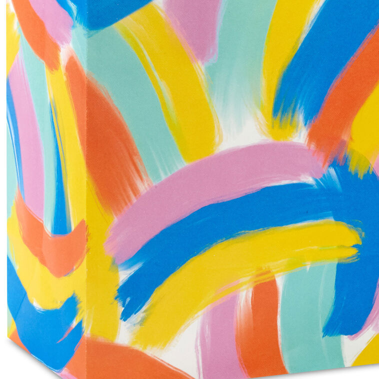 Hallmark medium gift bag with colorful abstract brushstroke rainbows in purple, blue, yellow, and orange on a white background