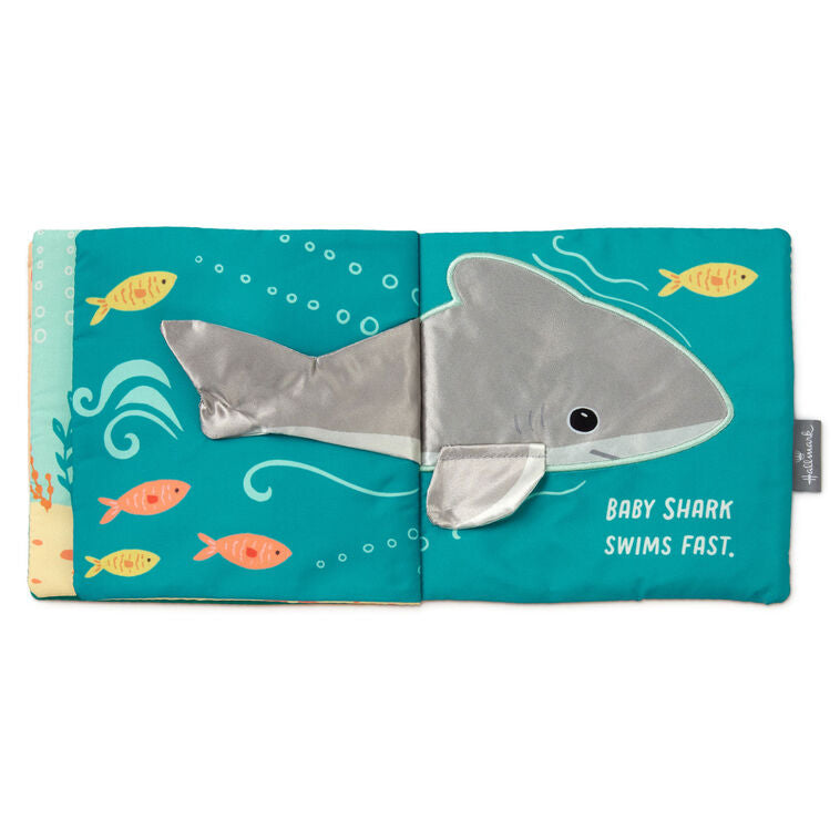 Ocean-themed baby fabric book with sea creature illustrations and tactile features like crinkle paper, squeaker