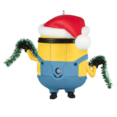 Minion Bob ornament in Santa hat holding green tinsel garland with a big smile