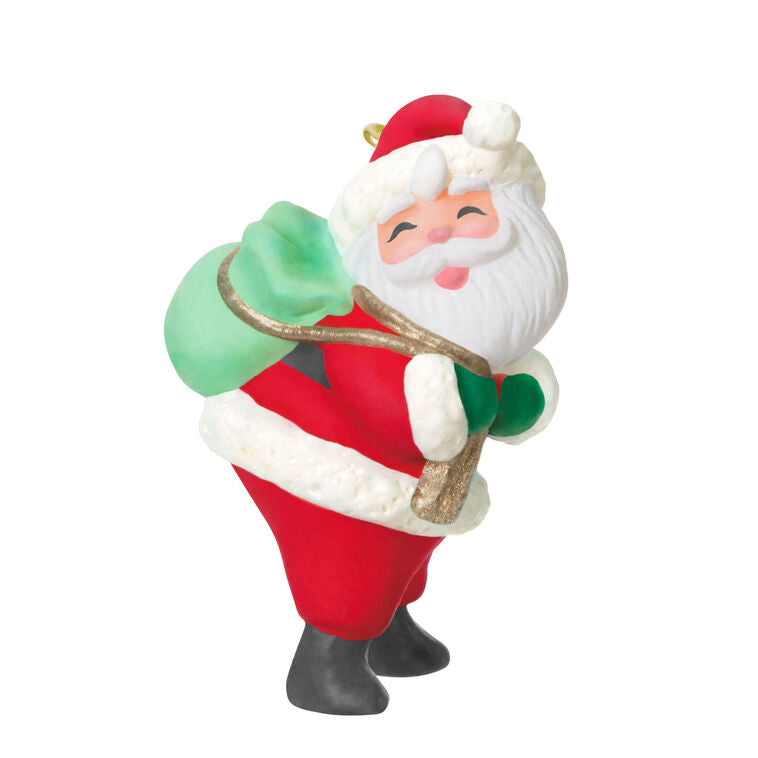 Mini Santa Claus ornament with rosy cheeks and green toy sack, retro-styled Hallmark Keepsake Christmas collectible