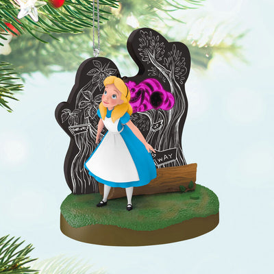 Alice stands in Wonderland before a glowing tree as the Cheshire Cat fades in and out in this Hallmark Keepsake Disney ornament.