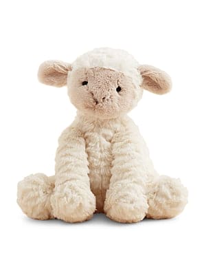 Stuffed sheep sitting on white background