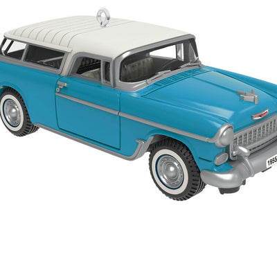 Miniature 1955 Chevrolet Nomad Wagon Christmas ornament in blue and white, featuring vintage styling, turning wheels, and silver accents.