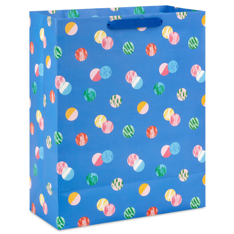 Hallmark extra-large gift bag with playful polka dots on a blue background, ideal for birthdays, holidays, or celebrations.
