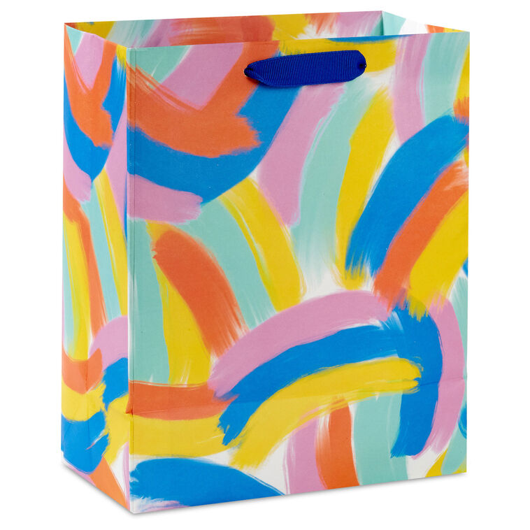 Hallmark medium gift bag with colorful abstract brushstroke rainbows in purple, blue, yellow, and orange on a white background