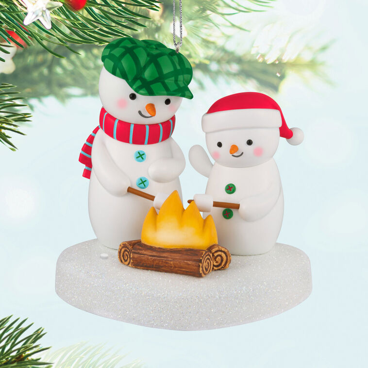 Two snowmen in red and green hats roasting marshmallows over a fire, sparkly base, musical Christmas ornament, battery opera
