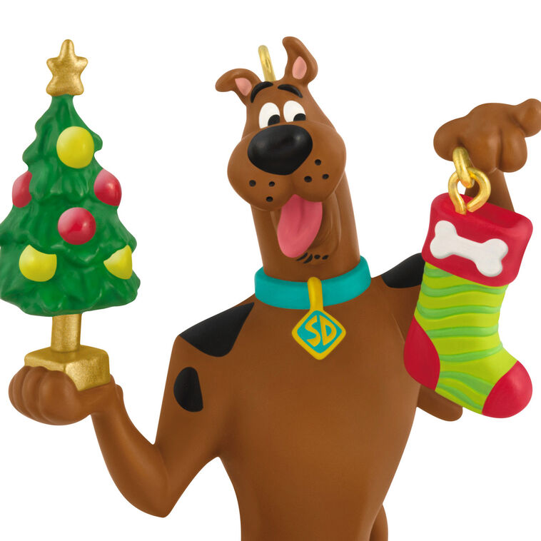 Hallmark Keepsake Tom and Jerry ornament featuring Tom the cat holding Jerry the mouse as a sandwich, with a red napkin tied around his neck.