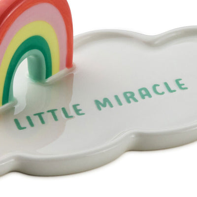 Ceramic cloud-shaped figurine with colorful rainbow arch and “Little Miracle” message in blue lettering.