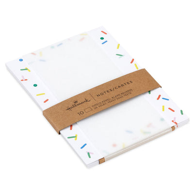 White flat note cards with colorful confetti sprinkle border design, bundled in kraft paper wrap.
