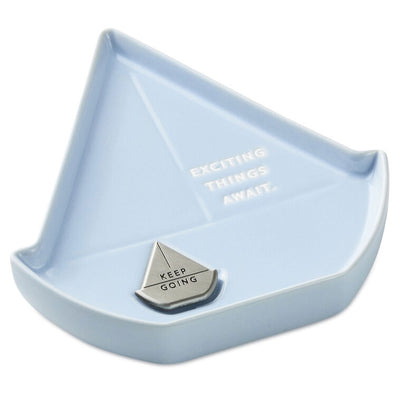 Light blue sailboat-shaped Hallmark trinket dish with removable “Keep going” token and inspiring message.