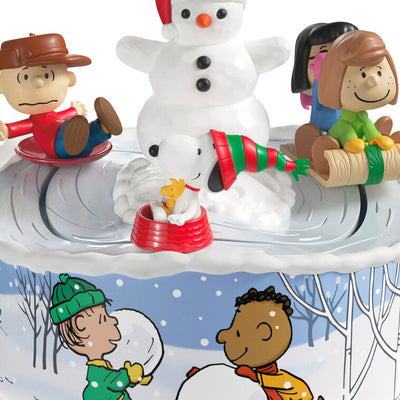 Peanuts Gang sledding ornament with Snoopy, Lucy, and snowman, light-up musical Christmas scene, Hallmark Keepsake motion collectible
