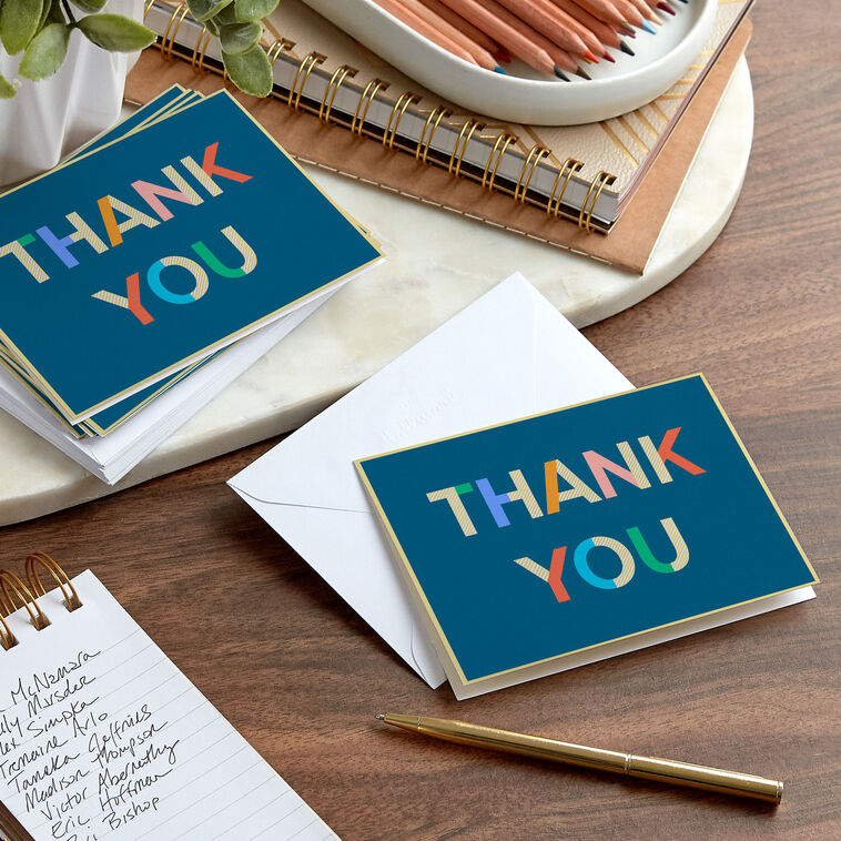 Colorblock thank-you cards with multicolor lettering on navy blue background and gold foil accents.
