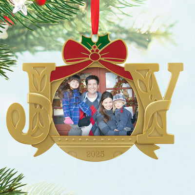 Gold JOY word-art photo frame ornament with red bow and holly topper, features 2025 date and holds a small holiday photo.