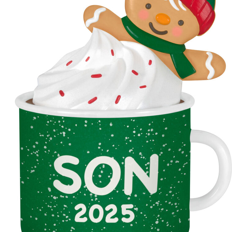 2025 Christmas ornament of gingerbread son cookie in green mug with whipped cream, festive holiday design

