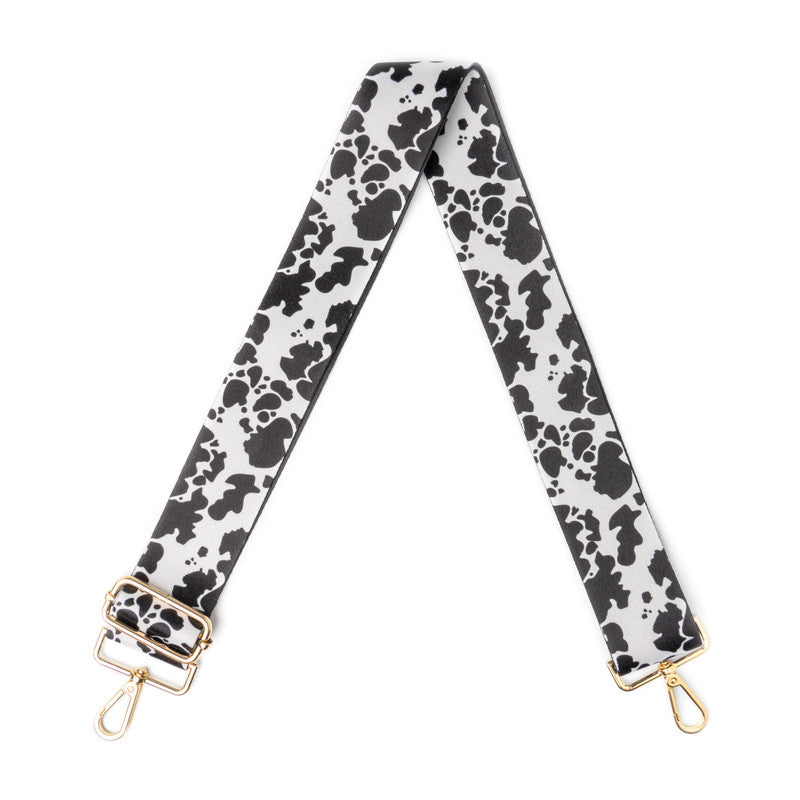 Adjustable shoulder strap in cow print pattern, designed to pair with multiple bags and outfits.