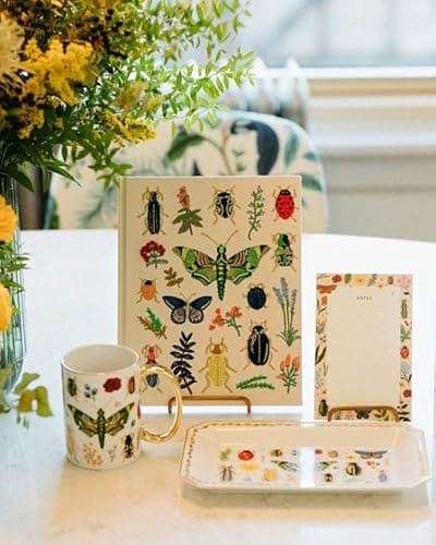 Rifle Paper Co. Bugs and Herbs notepad with a white center, colorful illustrated herb and insect border, and warm white tear-off pages.
