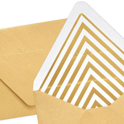 Gold metallic envelopes with white and gold chevron liner and pointed flaps, perfect for cards and special occasions.
