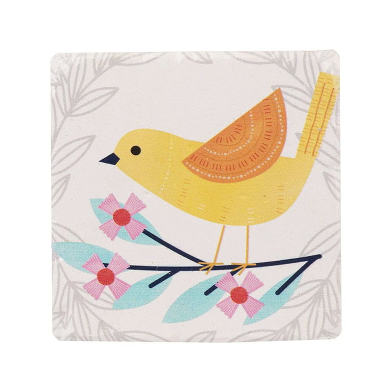 A set of four white resin coasters with blue and yellow birds perched on leafy branches in vibrant colors