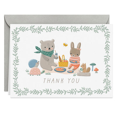 Baby thank you cards with bear and bunny picnic illustration framed by greenery, includes 10 blank white cards and kraft envelopes