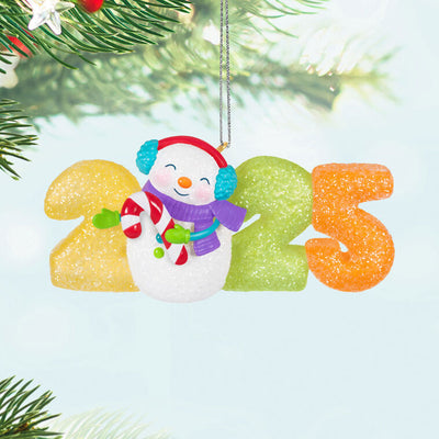 Hallmark Keepsake Sweet Decade 2025 ornament—snowman in purple scarf and blue earmuffs with candy cane, surrounded by glittery gumdrop “2025” numbers
