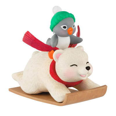 Tuxedo penguin in green hat rides Snowball the polar bear on toboggan, Hallmark Keepsake Christmas ornament