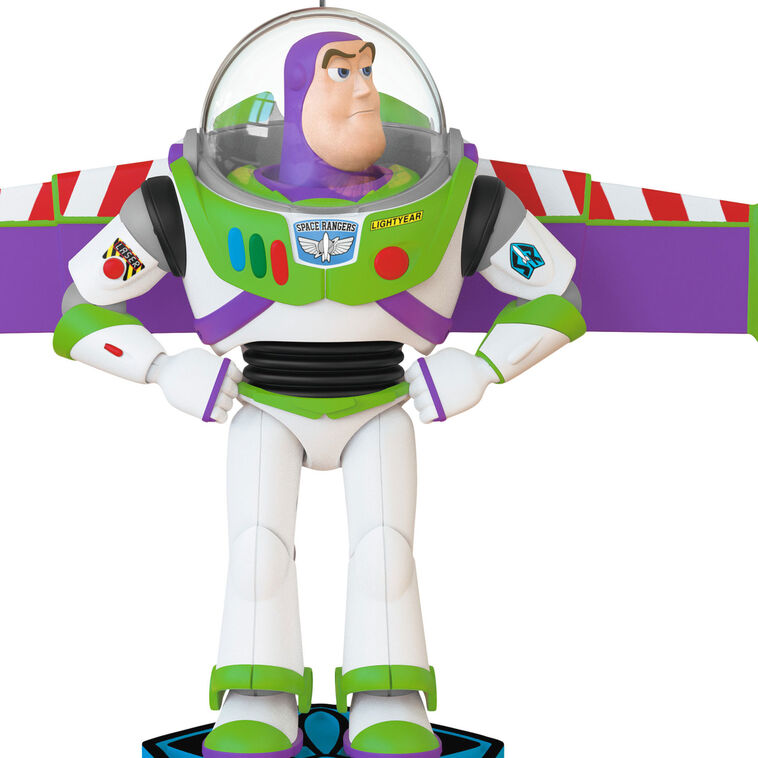 Buzz Lightyear Christmas ornament with wings extended on blue base, featuring light and sound effects