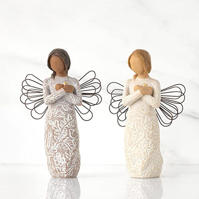 Willow Tree Remembrance angel with darker skin and hair, wire wings, gold leaf heart, and memory-themed carvings on dress.