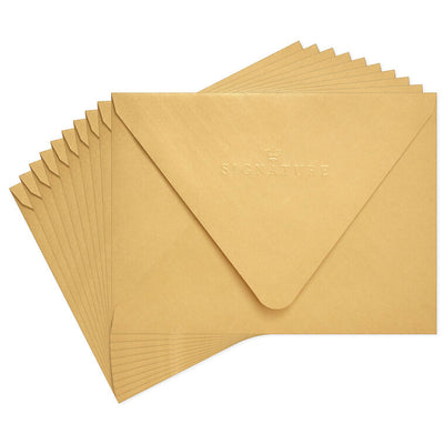 Gold metallic envelopes with white and gold chevron liner and pointed flaps, perfect for cards and special occasions.
