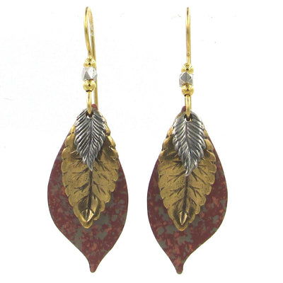 Layered leaf earrings with mixed metal tones and terracotta raku finish, handcrafted design.
