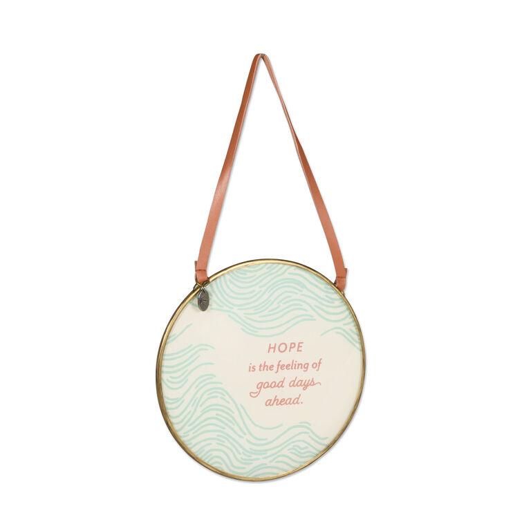 Round glass hanging plaque with gold frame, pink leaf illustrations, and inspirational message, Hallmark faith home decor

