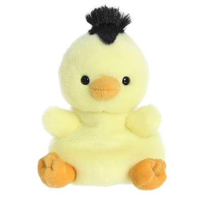 Yellow stuffed duck with a spiky red mohawk hairstyle. 
