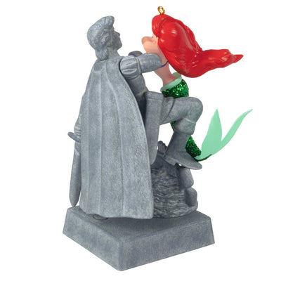 Ariel Christmas ornament gazing at Prince Eric's stone statue, tail curled behind her, from Disney's The Little Mermaid